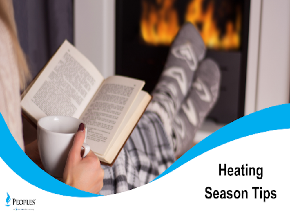 A person relaxes by a fireplace with a book and a mug, with text on the right reading “Heating Season Tips.”