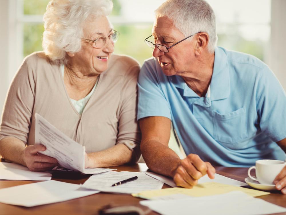 elderly couple with papers
