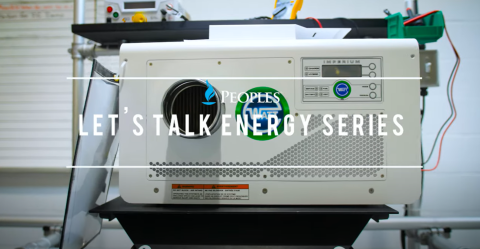 A white industrial device sits on a black stand in a workshop setting, with control buttons and vents visible on the front. Overlaid text reads “Peoples Let’s Talk Energy Series.”